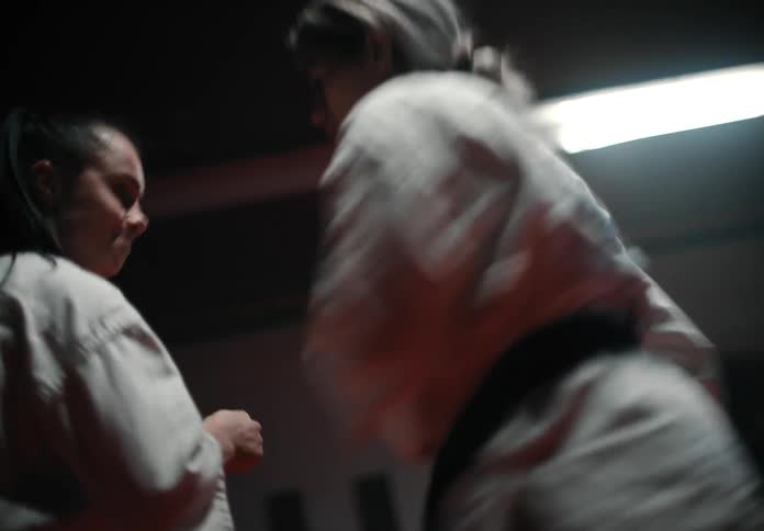 Two women are sparring in the gym