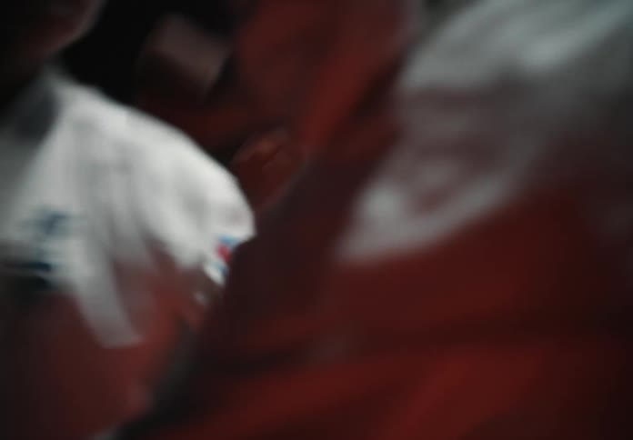 Two people are boxing together in a room