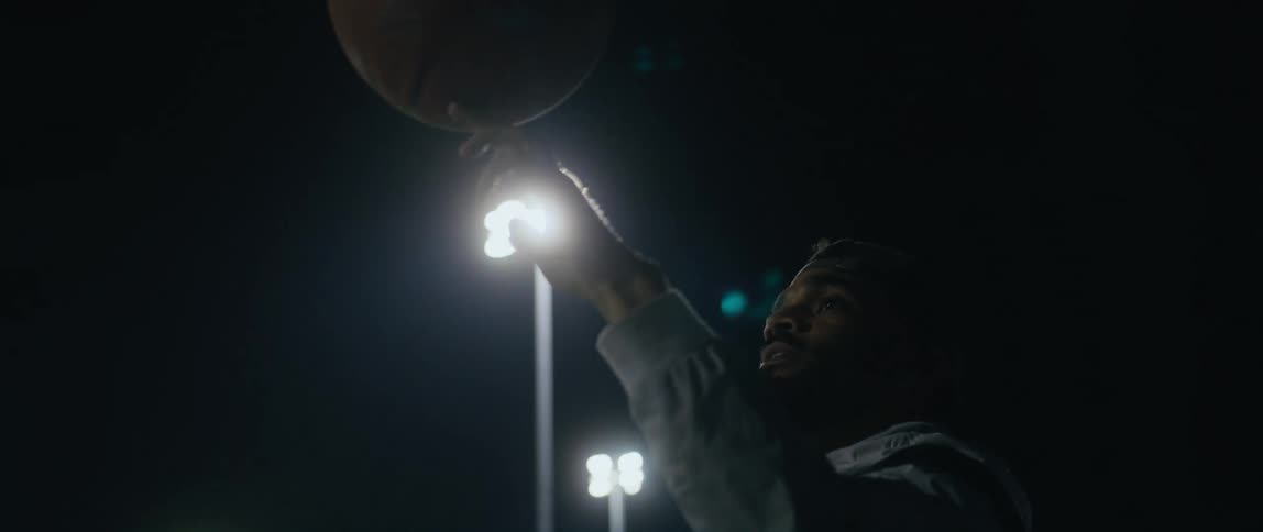 A man spins the basketball on his finger