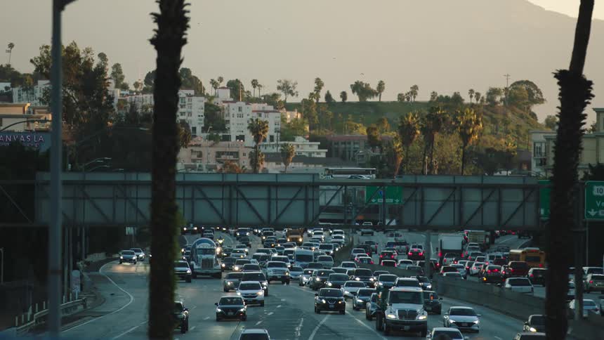 Heavy traffic flows through a downtown area on a freeway