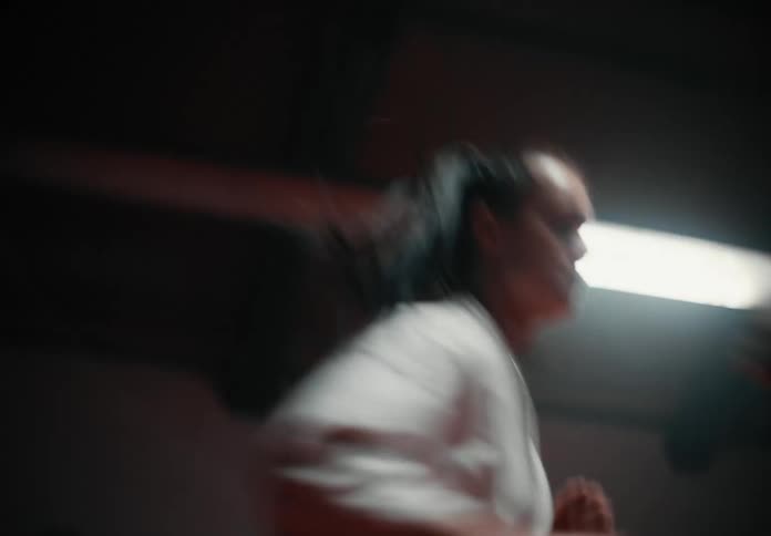 Two girls throw punches as they compete in a fight