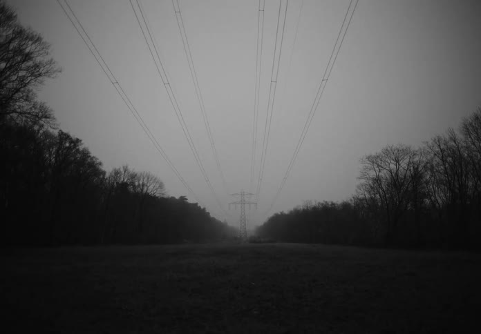 Power lines in a grassy field
