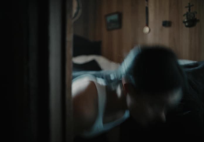 A young female athlete does push ups in her bedroom