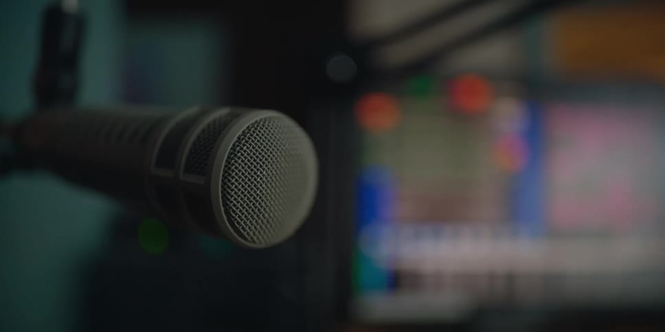 A microphone and a laptop are set up in a room