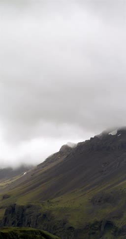 Rotated perspective of green mountain slope under overcast sky
