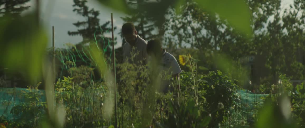 Father is hugging his son outdoors in spring