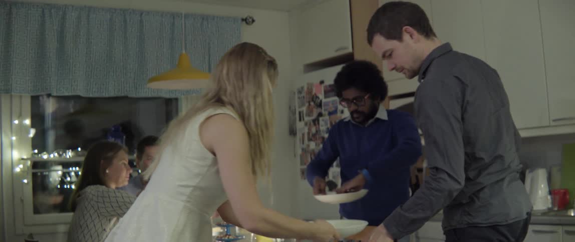 Young adults collaborating to prepare a stylish home interior for a communal family style meal.