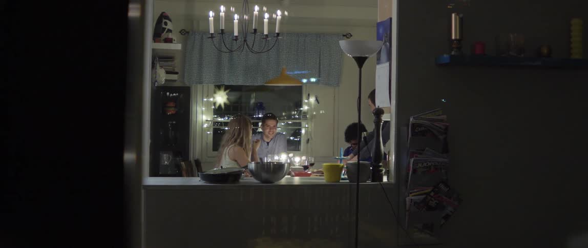 People Sitting at a Dining Room Table Talking Together With Warm Conversation and Connection
