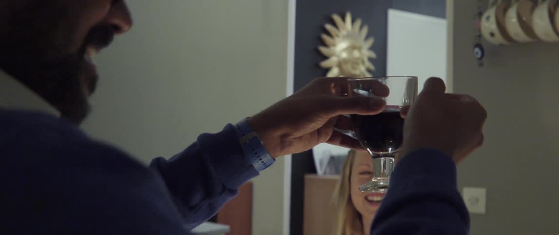 Man tapping a glass for a toast at lively dinner celebration