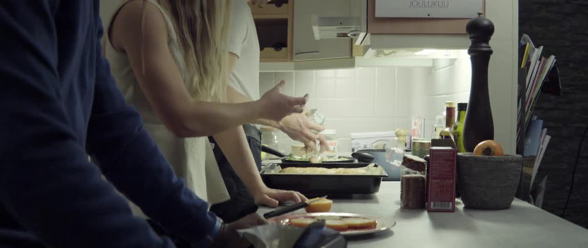 People Working Side by Side Preparing Food in a Kitchen With Warm Collaborative Energy