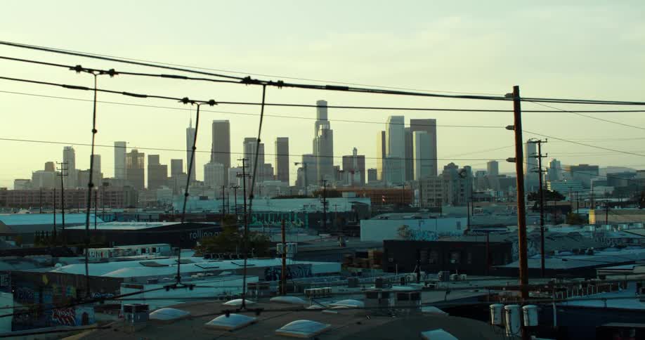 Light haze covers city skyline visible through power lines