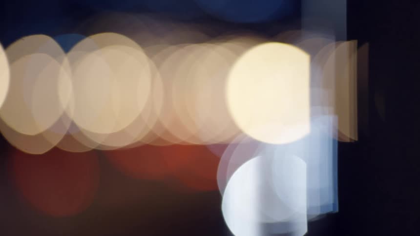 Blurred lights flash in the distance