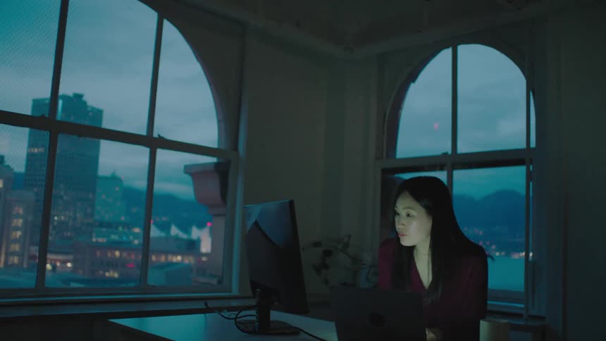 A woman is working in the office in the evening