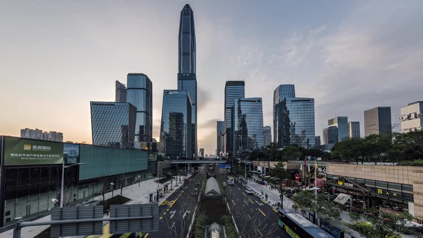 City traffic and civilians in downtown at dusk