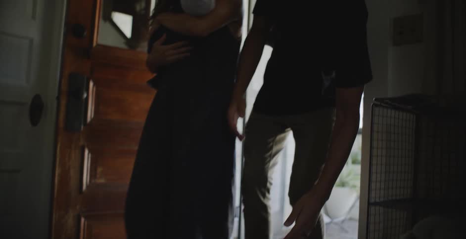 A father and mother walking into a house