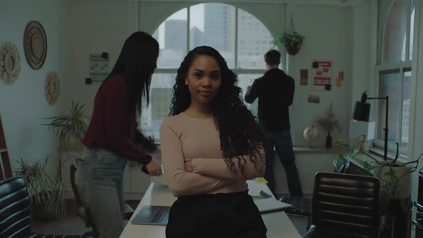 A group of people work together in a small office space