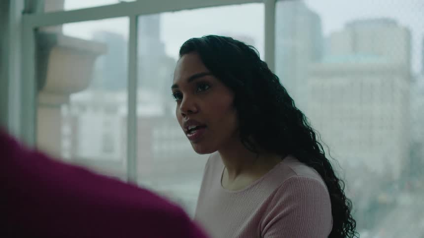 Two women are talking to each other in an office