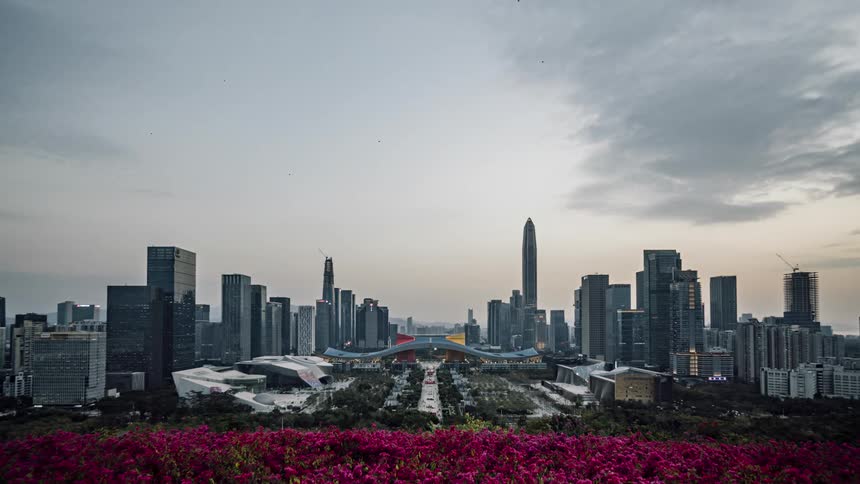 A large sprawling city has cloud cover rolling in