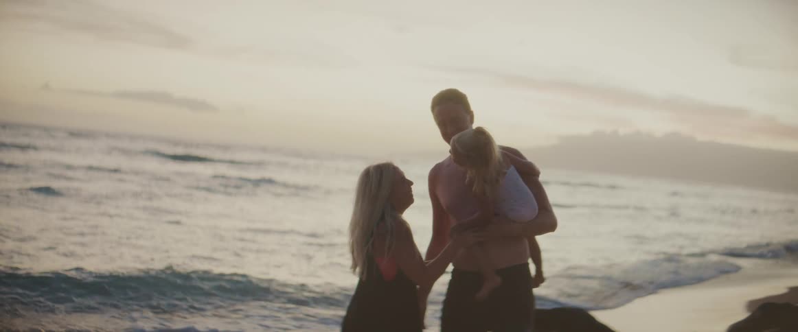 A family is hanging out and having fun outside by the beach