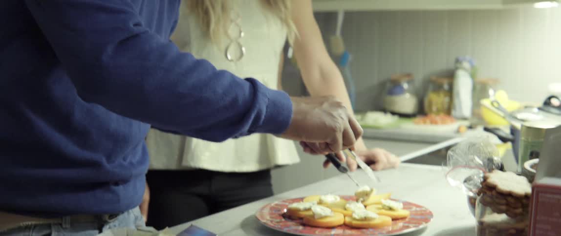 Man and Woman in a Kitchen Arranging Food on a Plate With Warm Shared Care