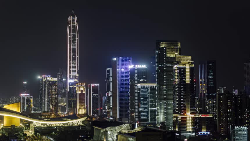 Aerial view of a downtown city at night is displayed