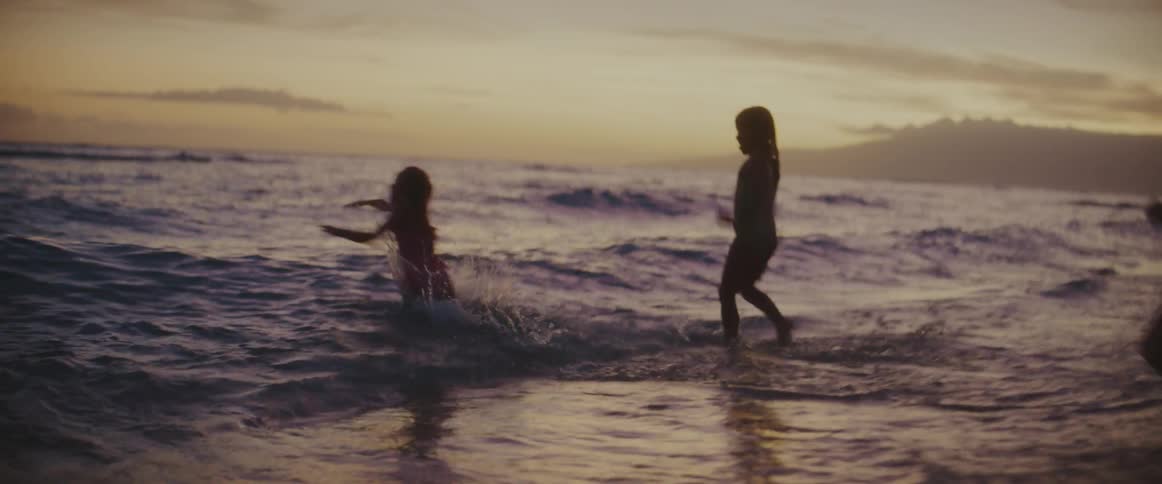 Children run into the water together
