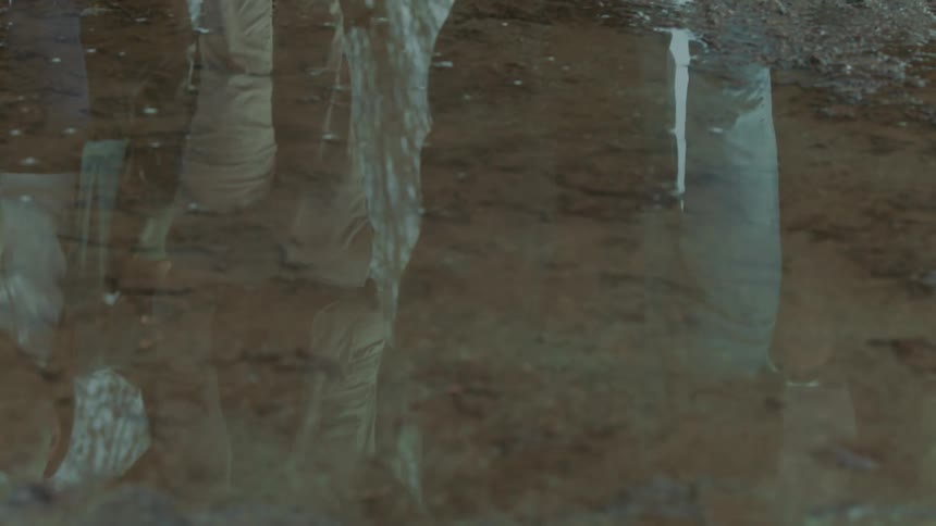 Protesters march through the puddle