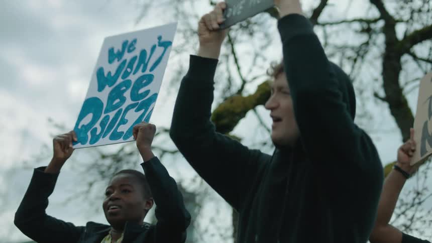 A group of people protesting with signs