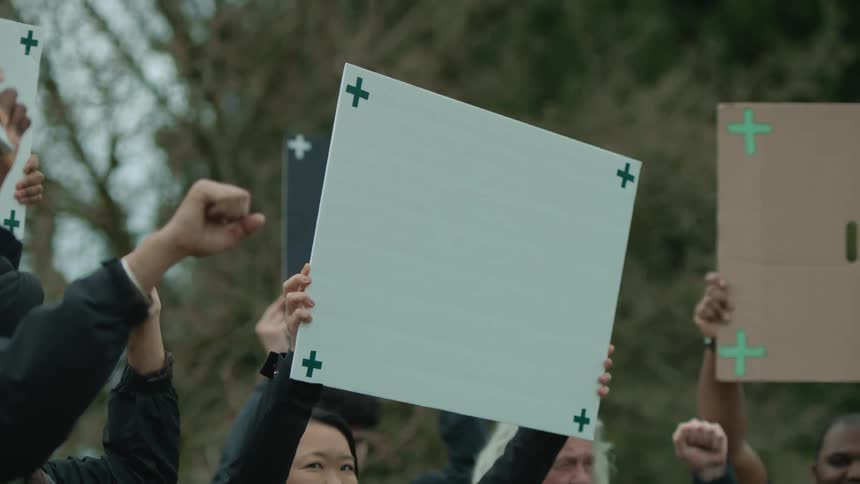 A group of men and women are protesting together