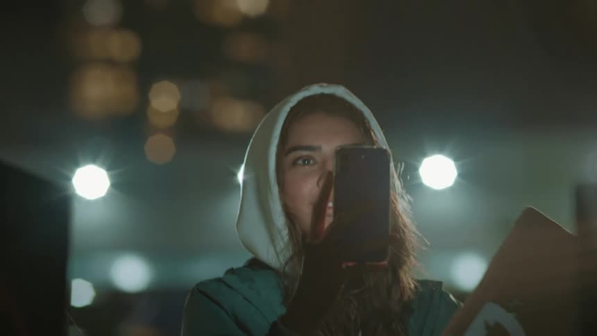 A woman is recording the protest with her phone