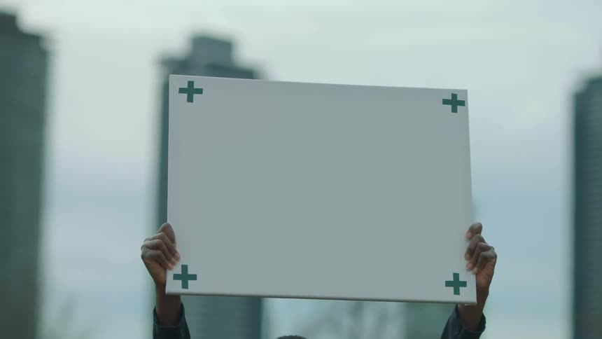 A person is holding a sign outside