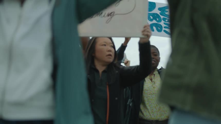 Protesters carry signs in the rally