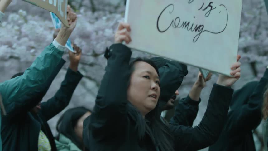 Protesters carrying signs march in the streets