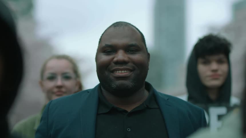 A group of people smile and stand together