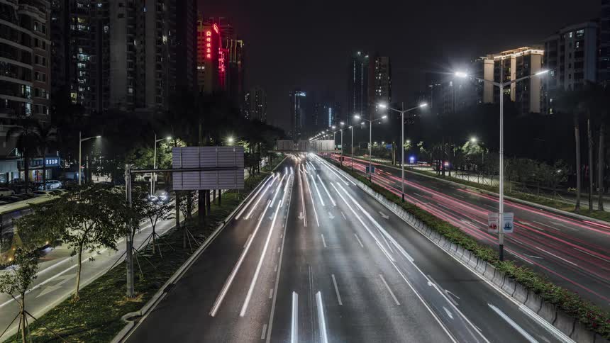 Traffic runs on the road by the city
