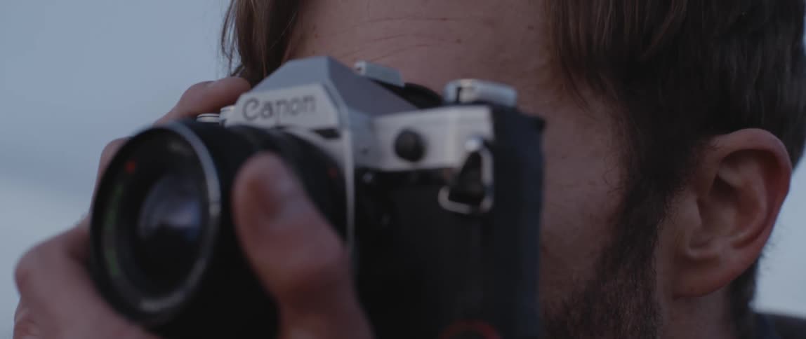 Man with red beard takes photographs
