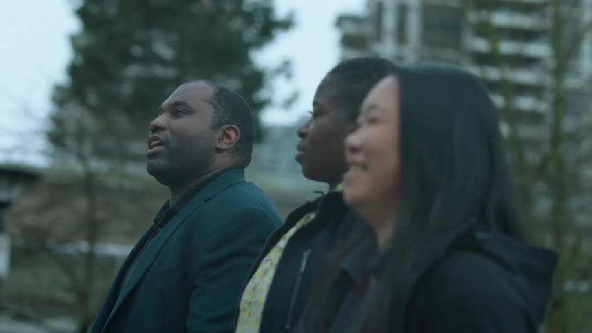 Three friends walking down the street of a big city while having a nice conversation together