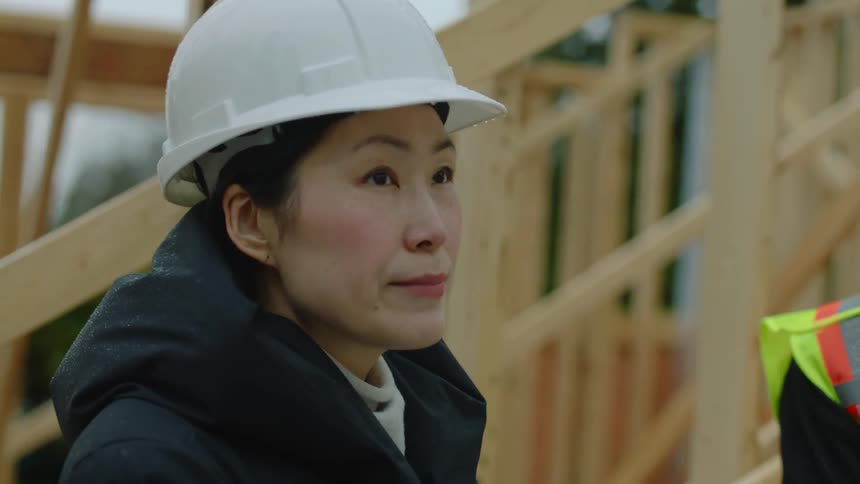 A group of construction workers are working outdoors at midday