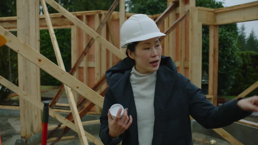 A female construction boss instructs an employee what to do on the job
