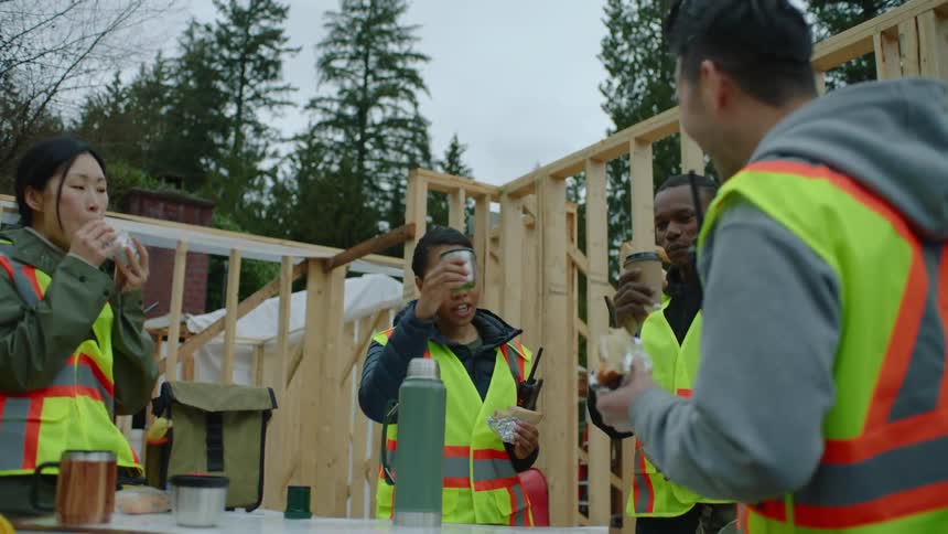 A construction crew stops to take a break for lunch and coffee