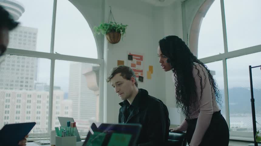 Coworkers are talking together in an office building