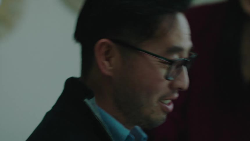 A female boss pats her employee on the shoulder encouragingly during a meeting