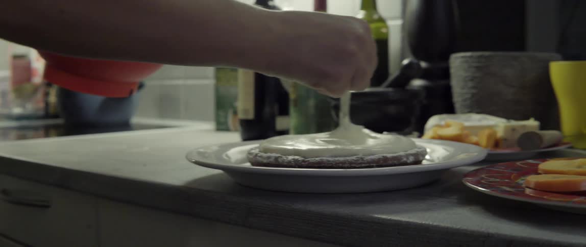 Person Carefully Decorating a Dessert With Delight and Precision in a Warm Kitchen Moment.