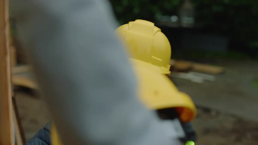 Man and woman are working a construction job outdoors