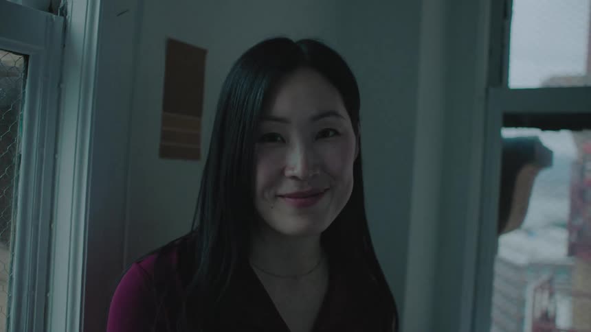 A young business woman is smiling and laughing in her office