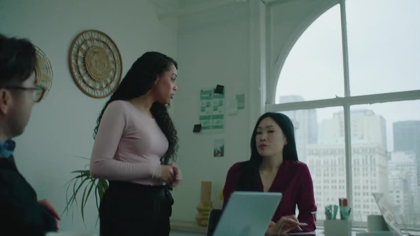 A group of business partners are talking together in a room