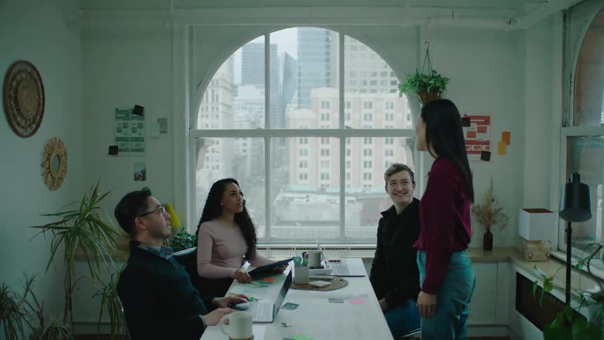 A woman is greeted in the office