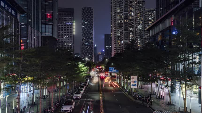 Time lapse view of traffic driving in a downtown city at night