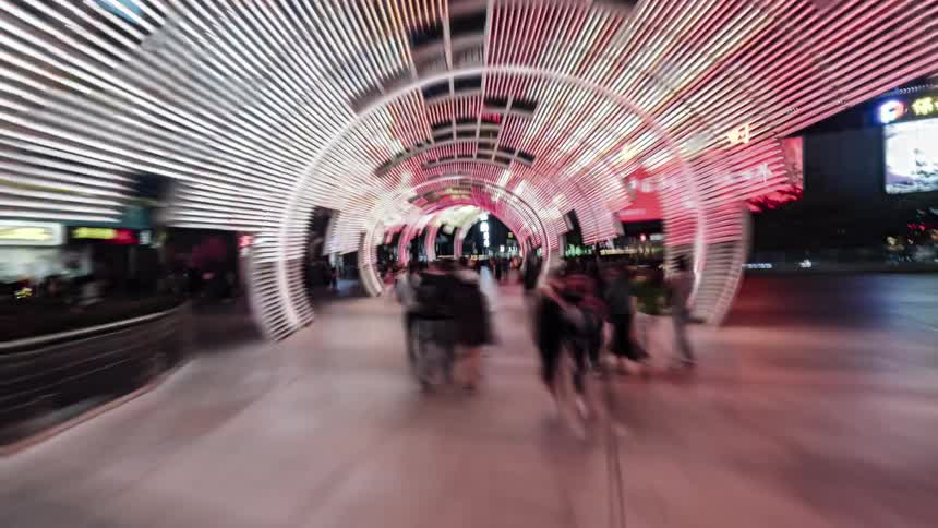 Pedestrians walk through the city at night