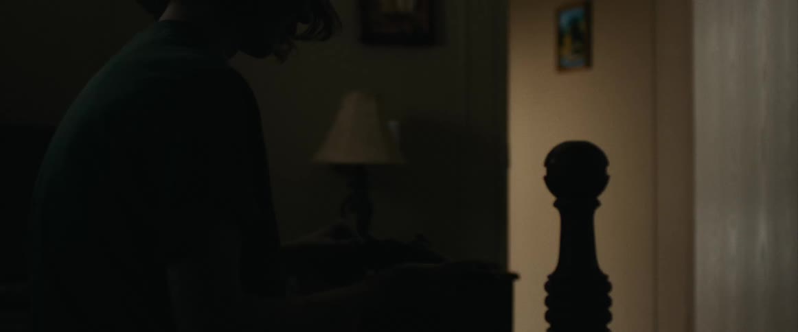 A man enters the doorway of the bedroom